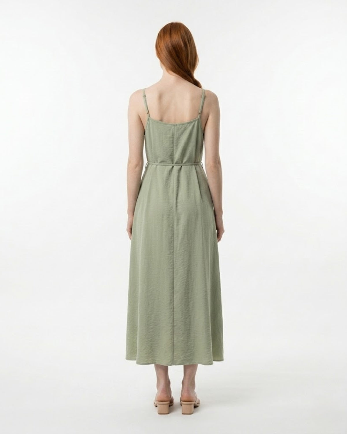 Woman wearing a green dress on a white background