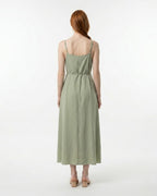 Woman wearing a green dress on a white background