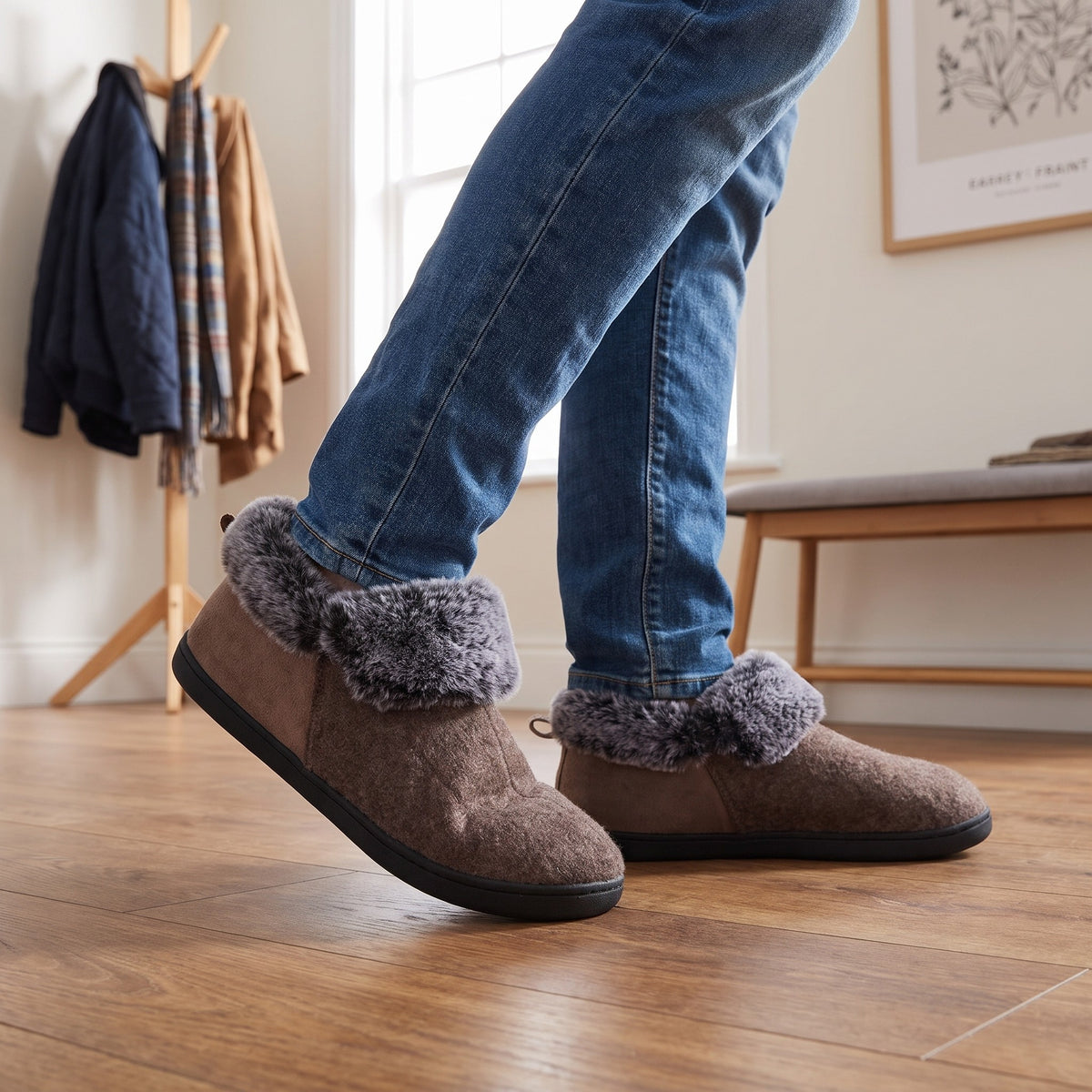 Man in jeans wearing mocha felt bootie slippers in a hallway