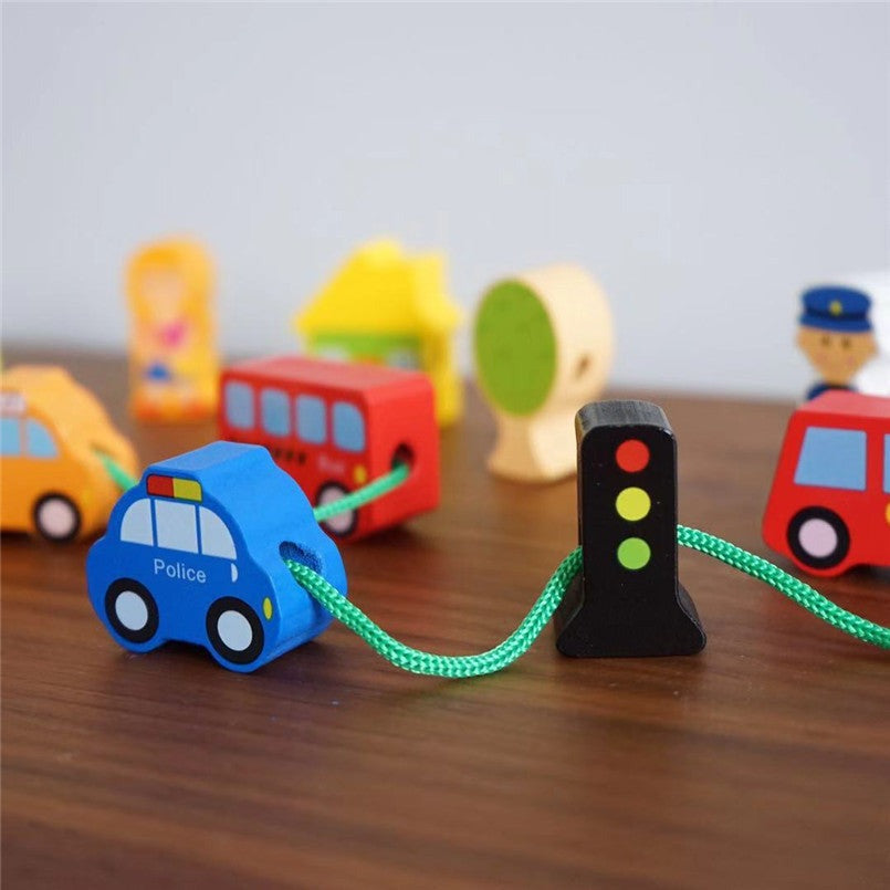 Police car and traffic light beads threaded on a green lace
