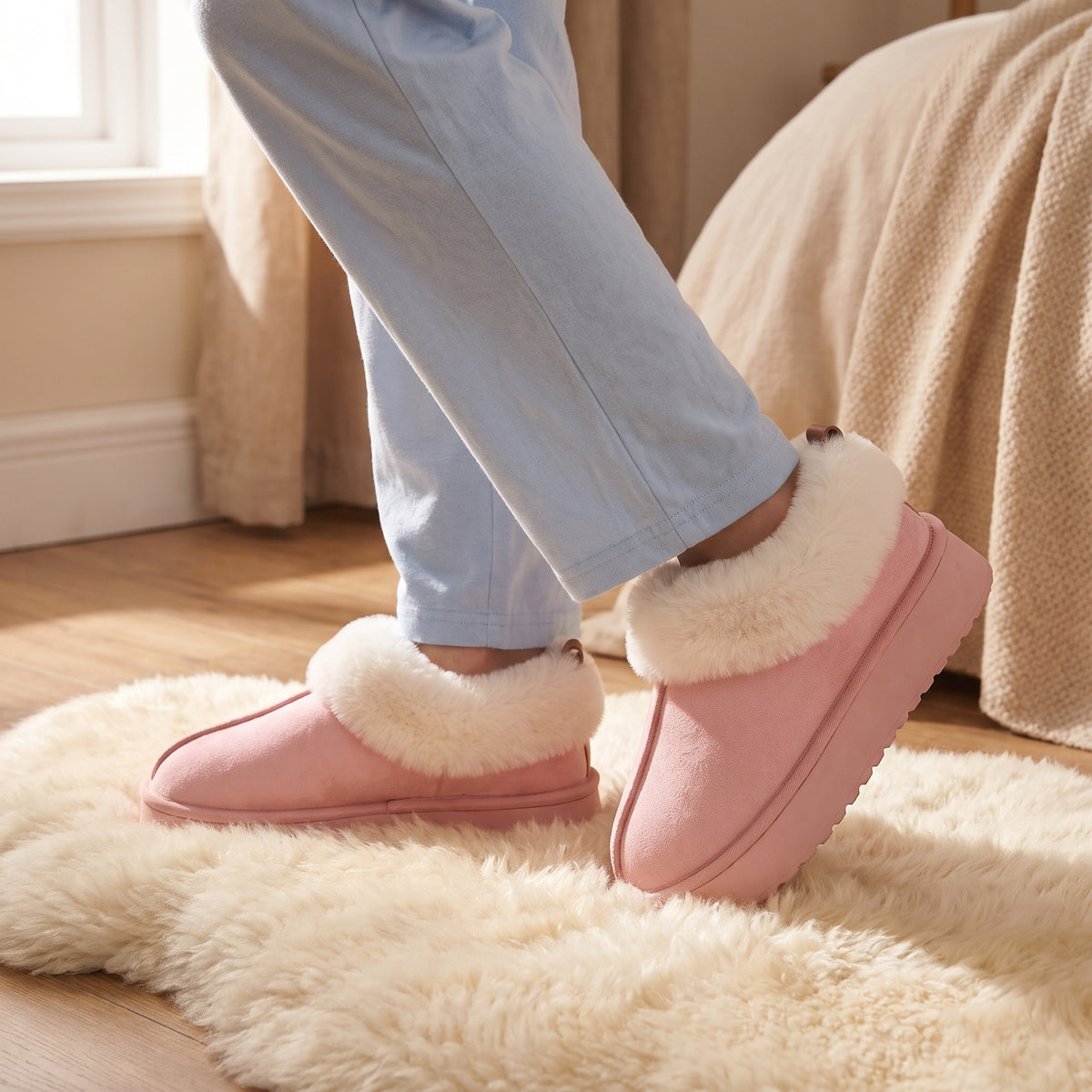 Woman on a sheepskin rug wearing pink fluffy slippers