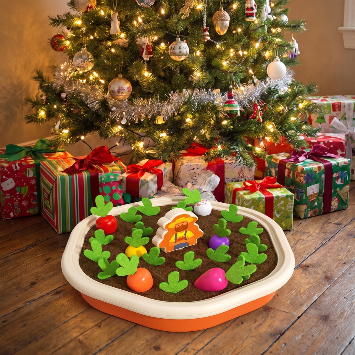 Radish pulling Montessori toy under a Christmas tree with wrapped presents