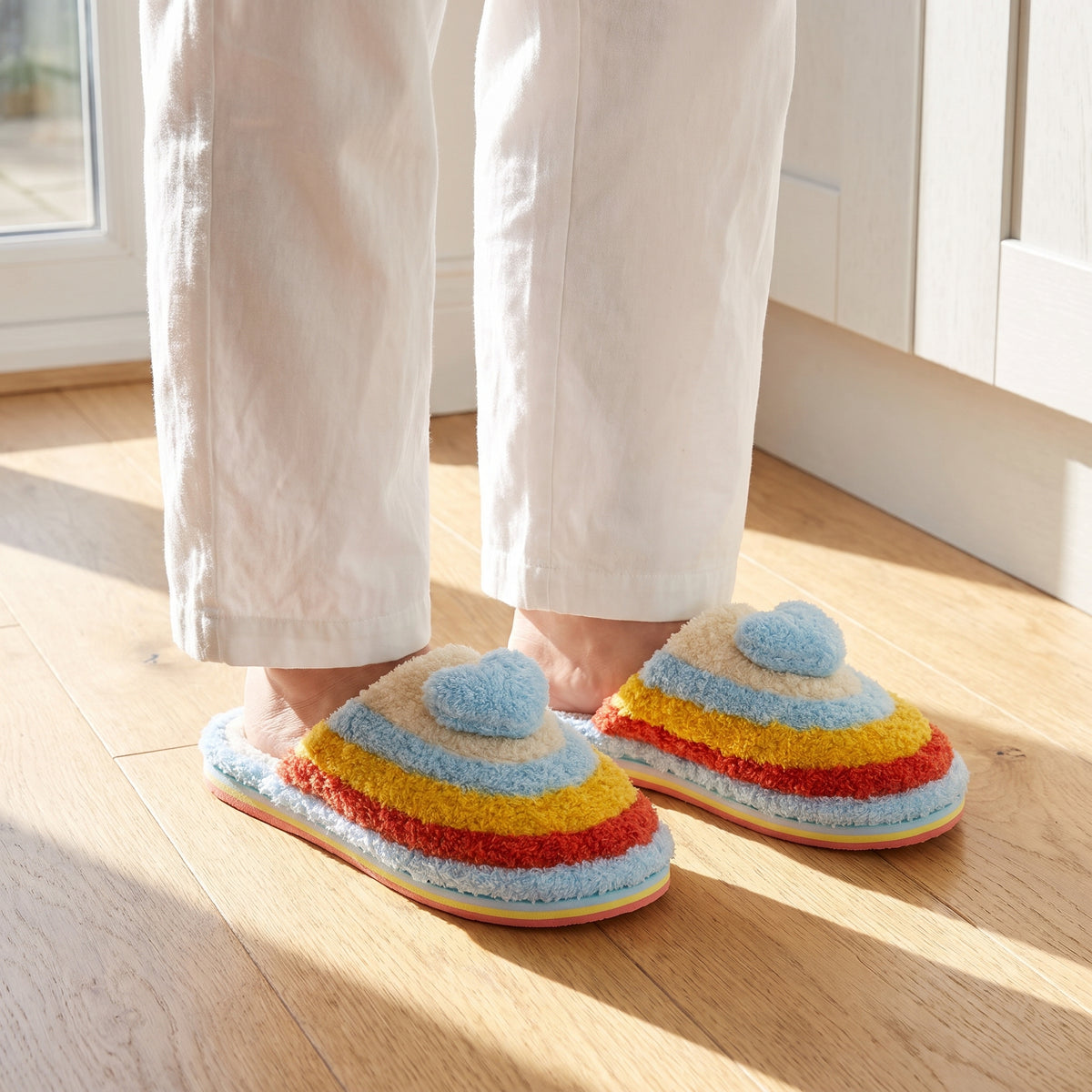 Woman in a kitchen wearing blue rainbow heart slippers