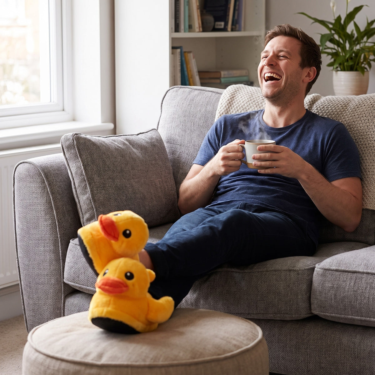 Laughing man relaxing on a sofa wearing yellow duck slippers