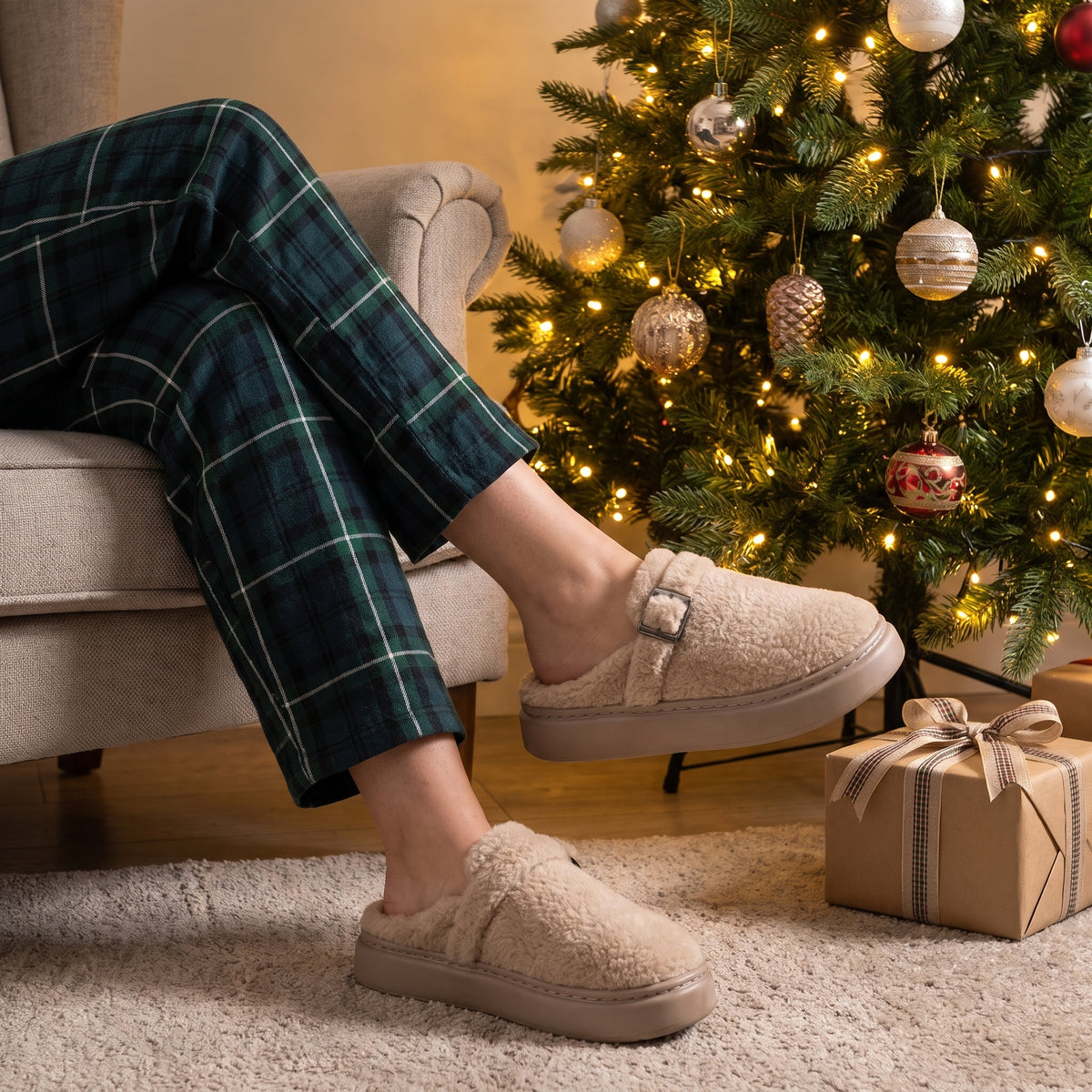 Woman by a Christmas tree wearing oatmeal fleece clog slippers