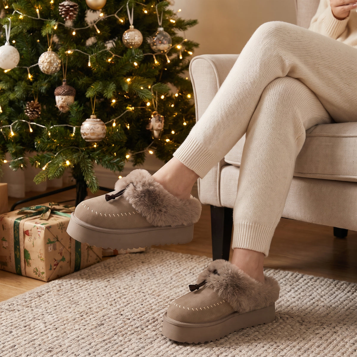 Woman by a Christmas tree wearing khaki fluffy platform slippers