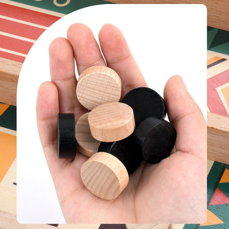 Eight beech wood pucks in natural and black held in a hand
