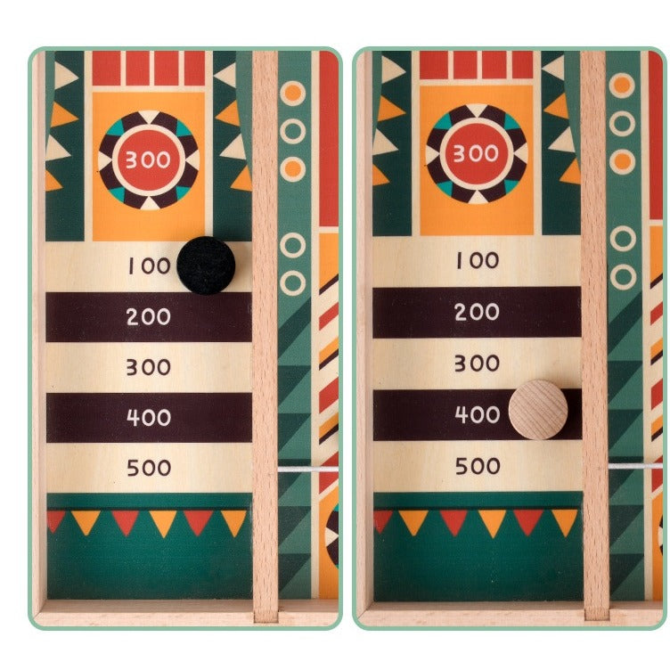 Wooden pucks landing in the 100 to 500 scoring zones at the end of the track