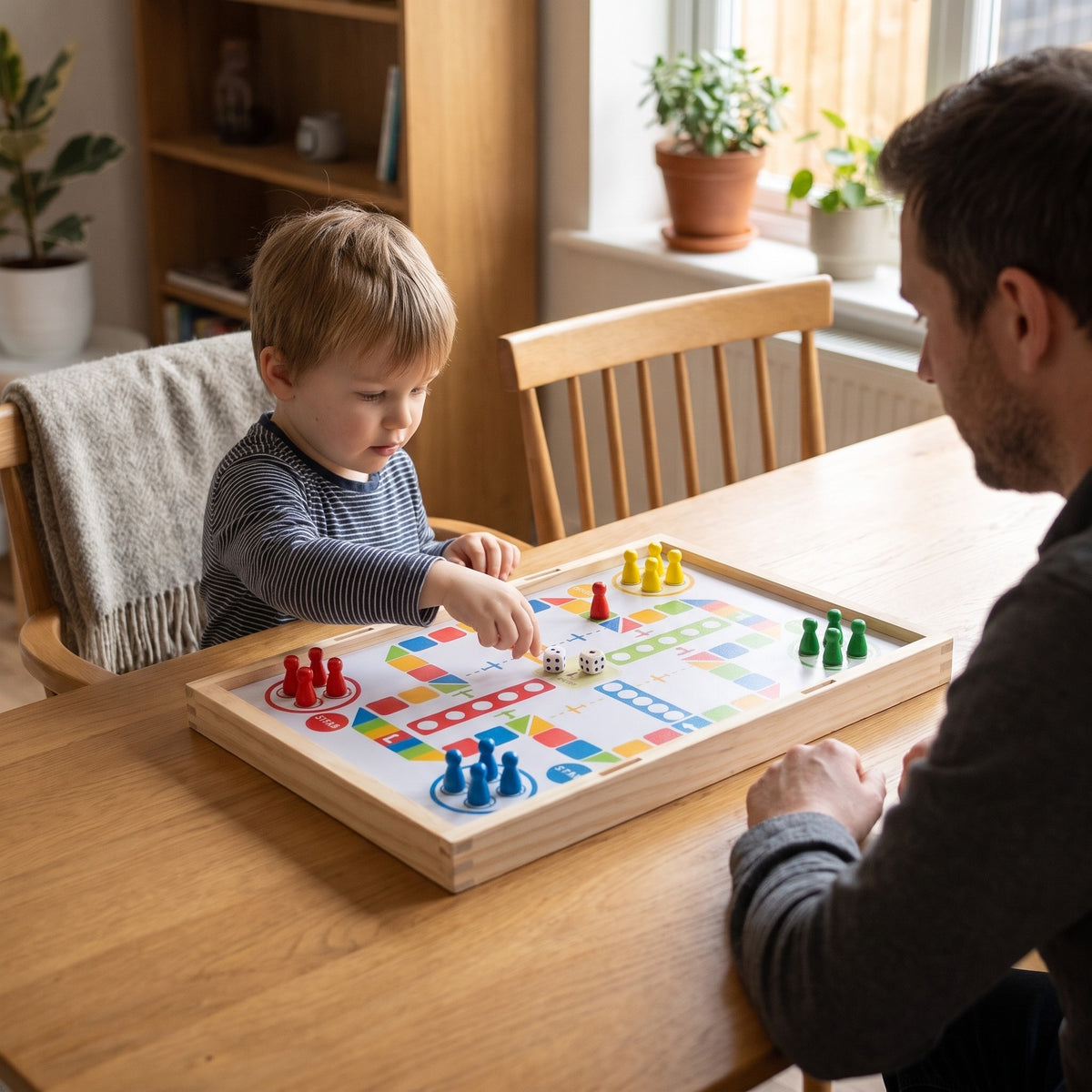 Parent and child playing ludo on the reverse of the wooden game board